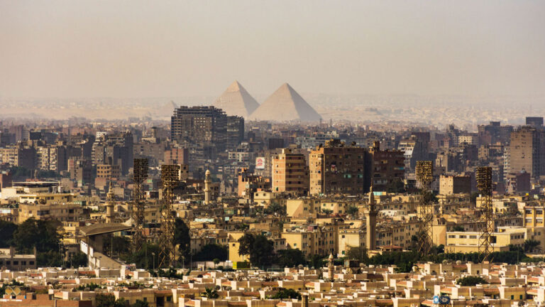 Panoramic view of city with pyramids in the background