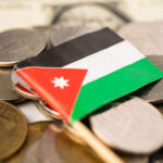 Flag of Jordan placed on top of the with currency