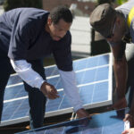 A group of engineers installing solar panels