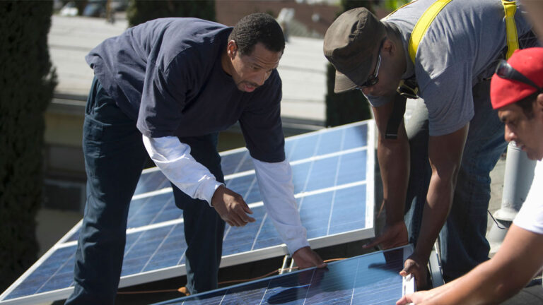 A group of engineers installing solar panels