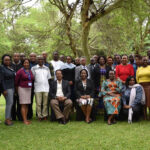 Group photo taken outside with trees in the background