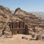 Building carved out of and built into rock face